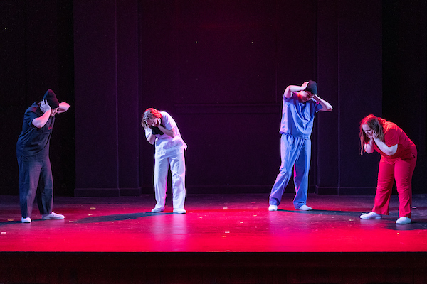 Students acting out a play on stage.