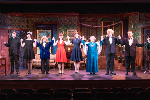 A group of students bowing at the end of a show on stage.