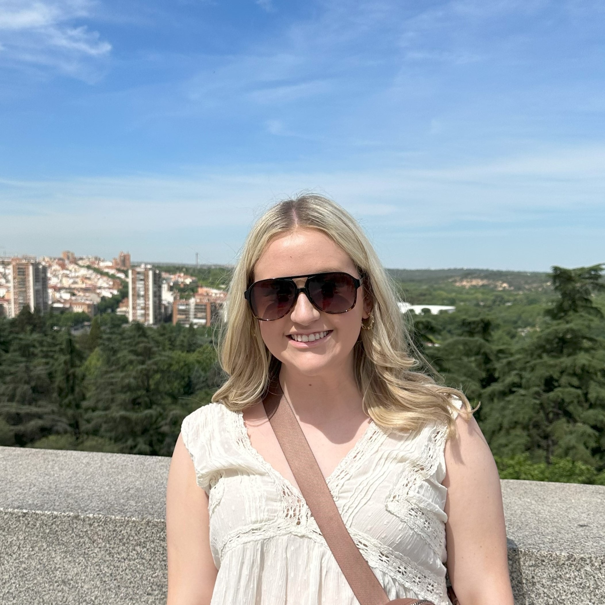 Addison Dorris abroad with a skyine behind her.
