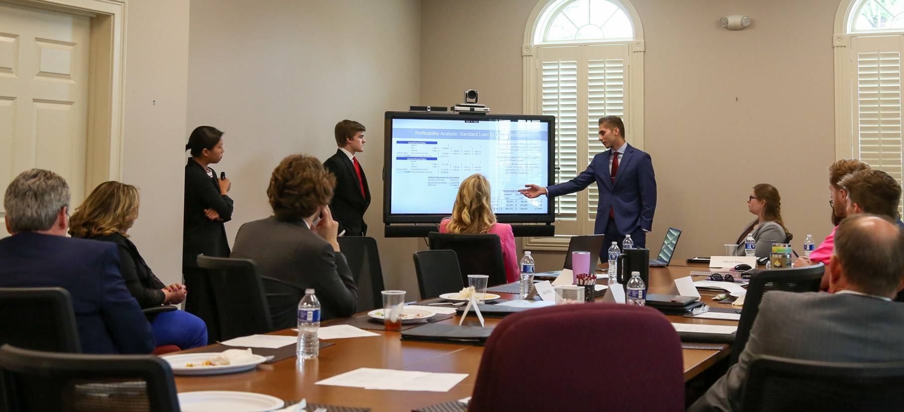 Students presenting to banking board