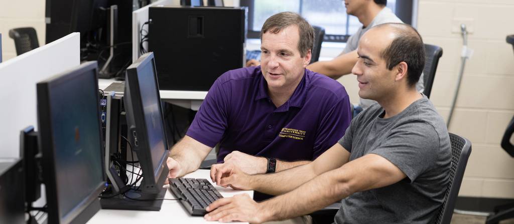 Faculty member teaching a student