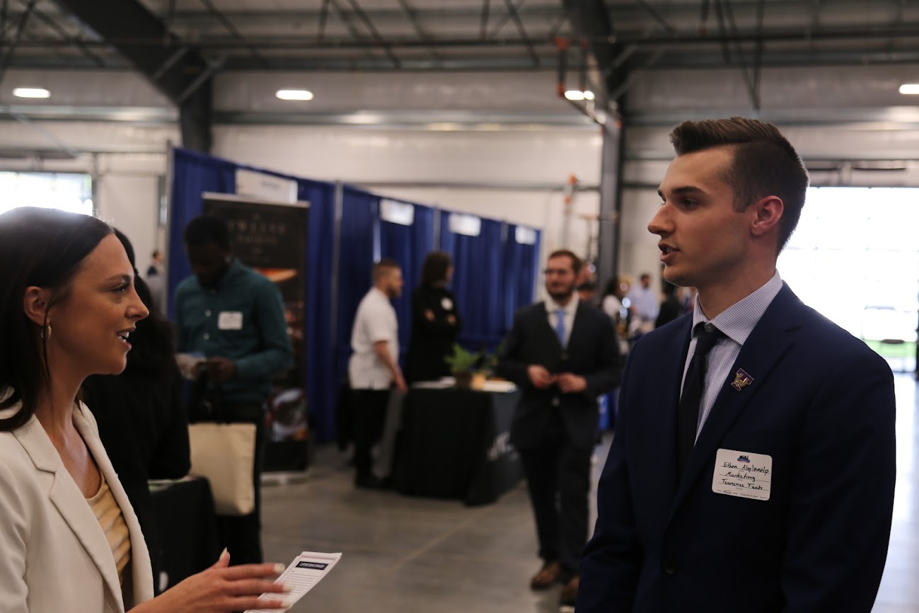 Ethan at the Nashville Area Career Fair talking to employer