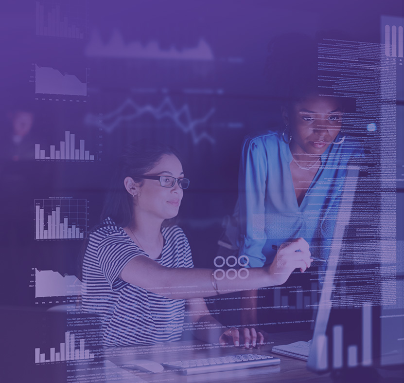 Two women studing data on a screen.