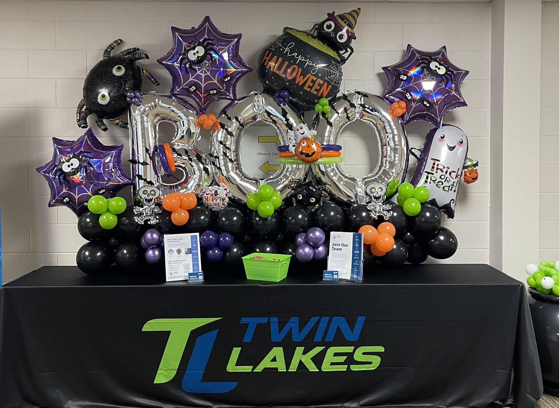 Twin Lakes Halloween information booth with colorful balloon arch