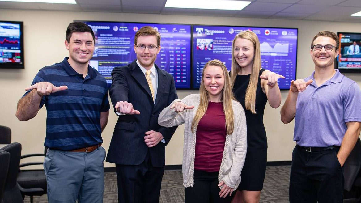 Students give wings up symbol in stock room