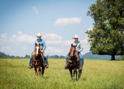 Agriculture students riding hourses.