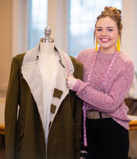A fashion student shows off a design