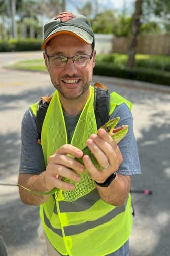 Dr. Joshua Hall holding a lizard
