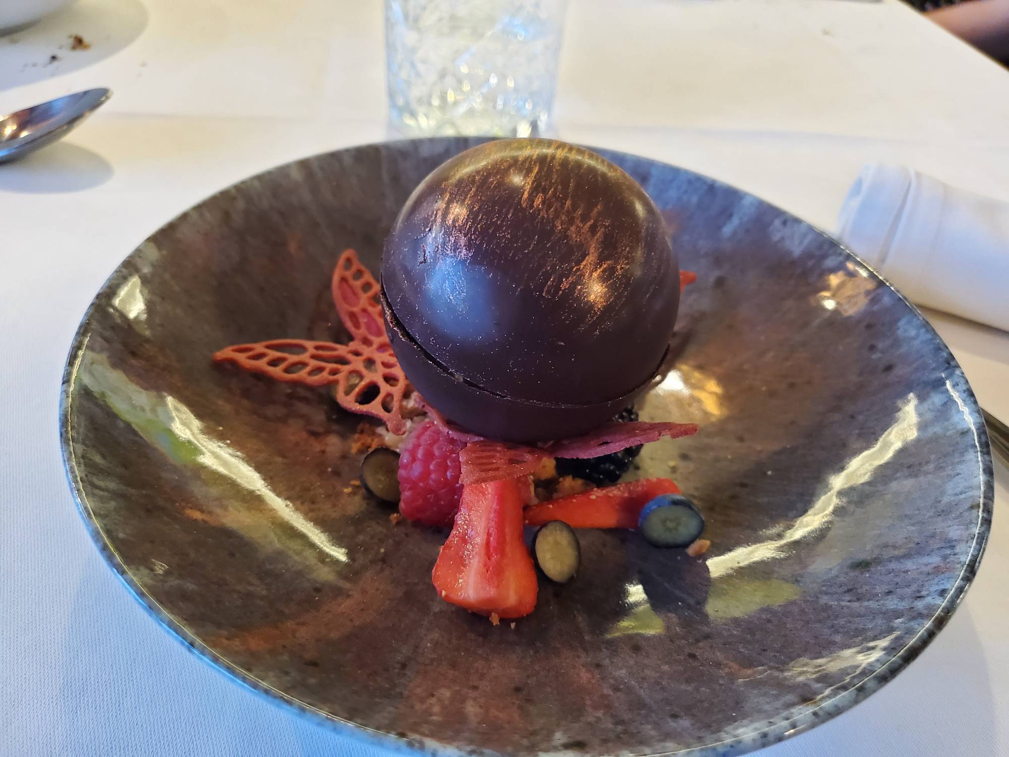 fresh fruit with a chocolate sphere on top