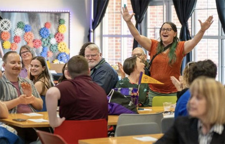 Audience celebrates educators.
