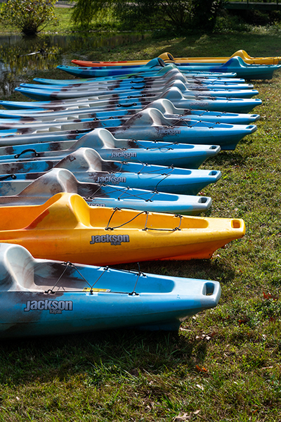A line of colorful kayaks ready to hit the river.