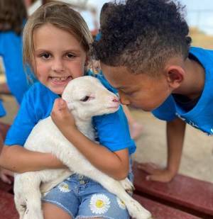 kids visit a farm with goats