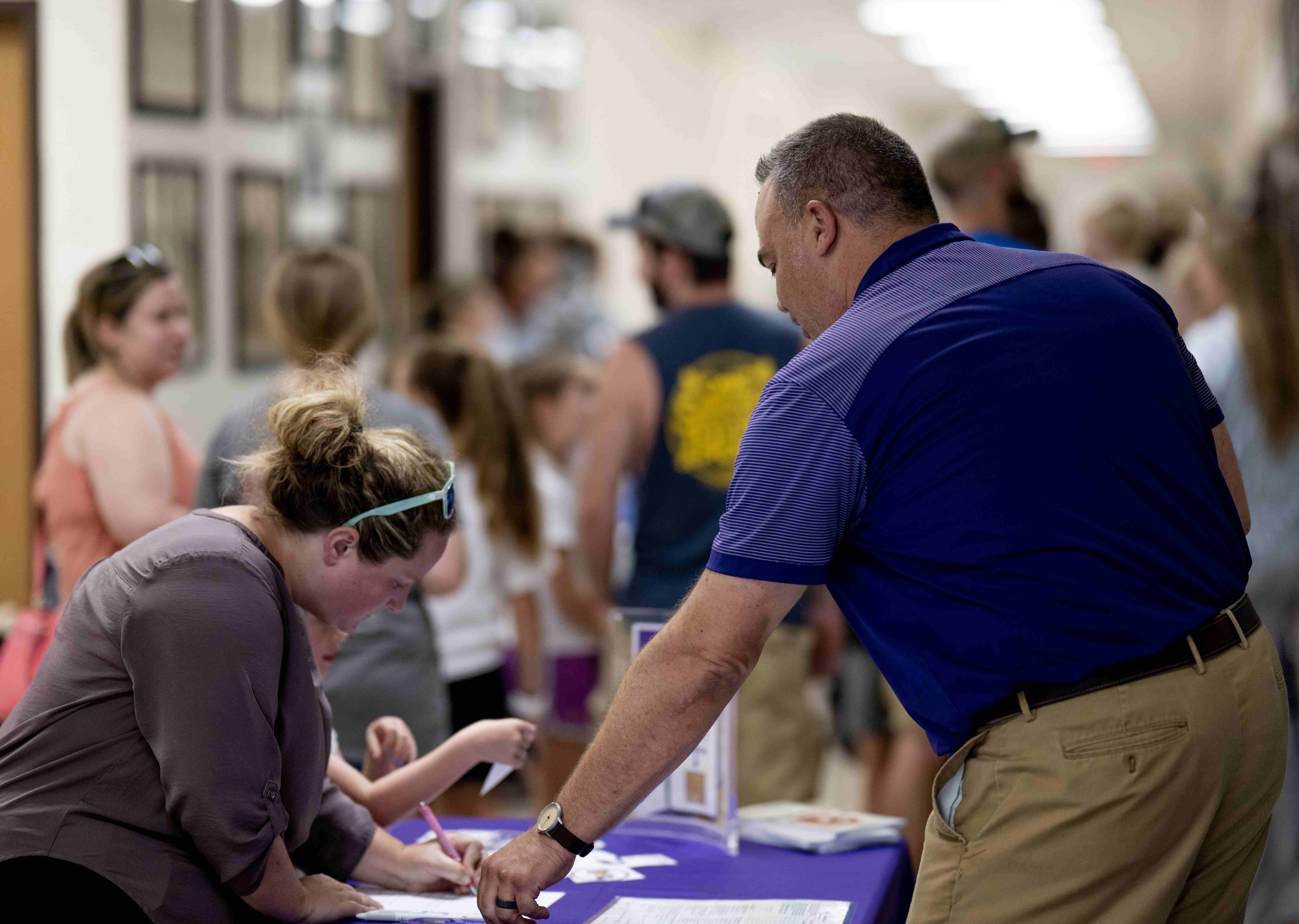 a person helping another person fill out information