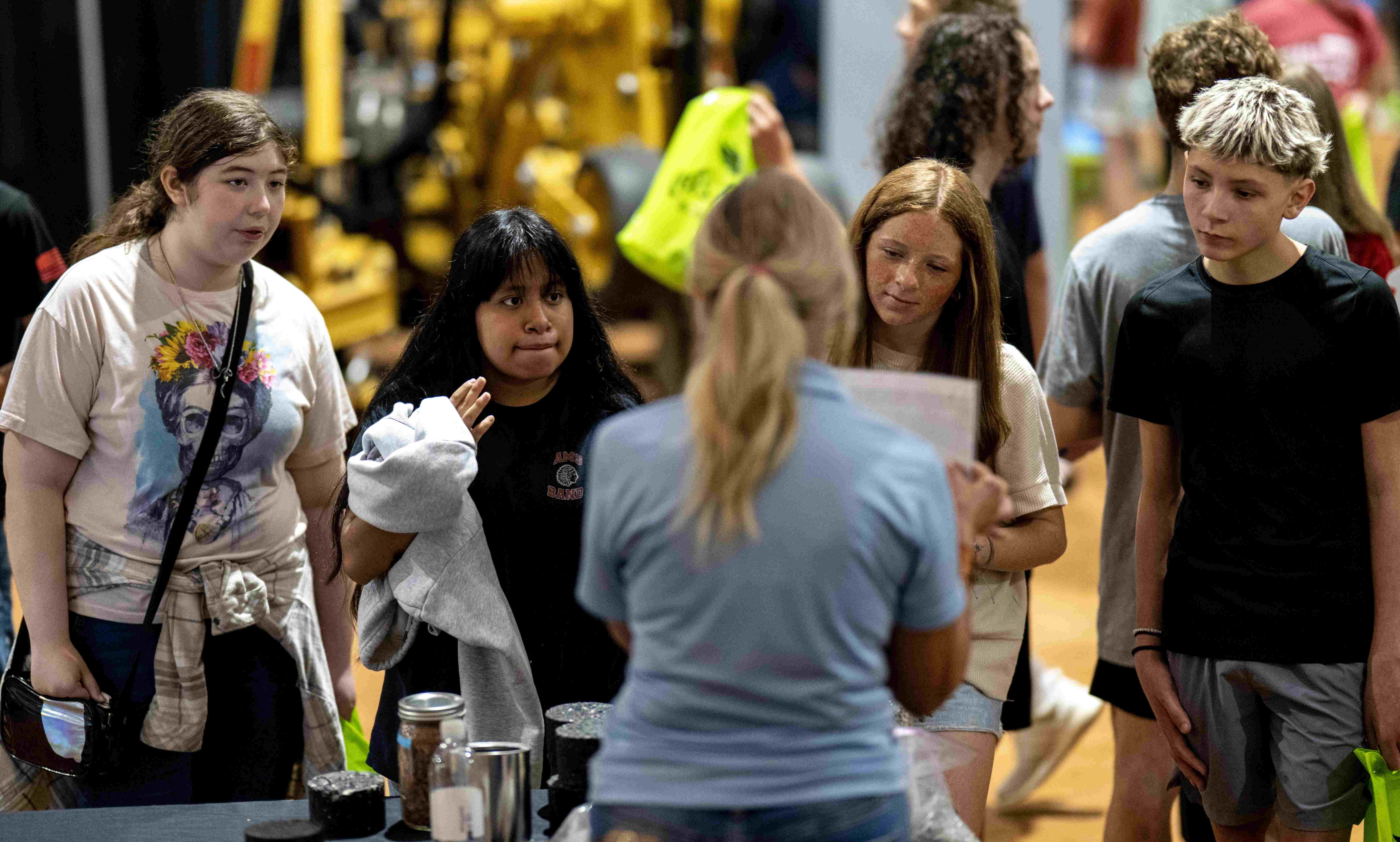 students talking to a vendor