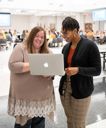 A Intercultural Affairs staff member assisting a student. 