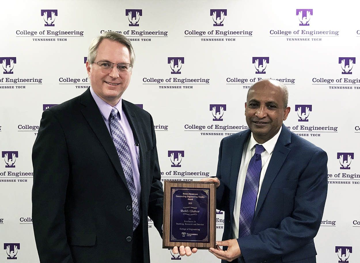 College of Engineering Dean Joseph C Slater presents the Brown-Henderson Award for 2021 plaque to Sheikh Ghafoor for 2021