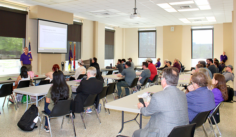 Members of the Tennessee Tech campus community gather at tables to listen to Dr. Bill Eberle speak.
