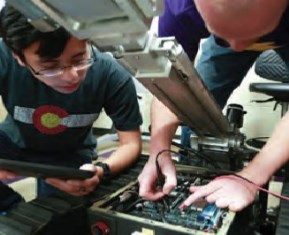 students working on robot motor