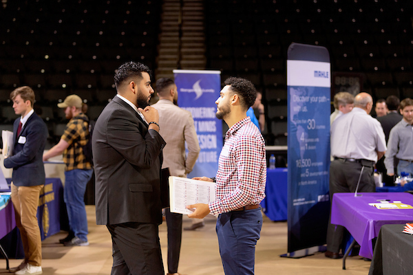 Students talking with industry representatives at the annual engineering career fair