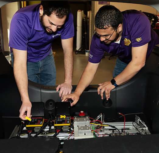 Students working on electric vehicle battery system