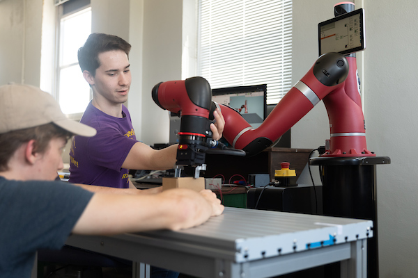 Students working with Collaborative robot 'Sawyer' in the robotics lab