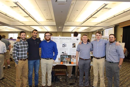 Students standing with their projects