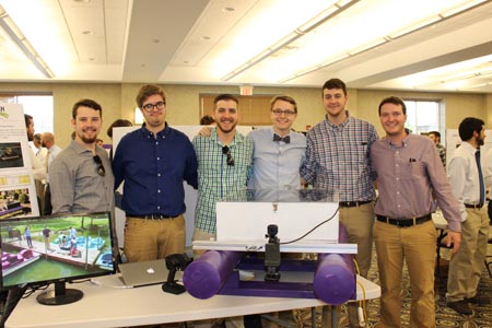 Students standing with their project