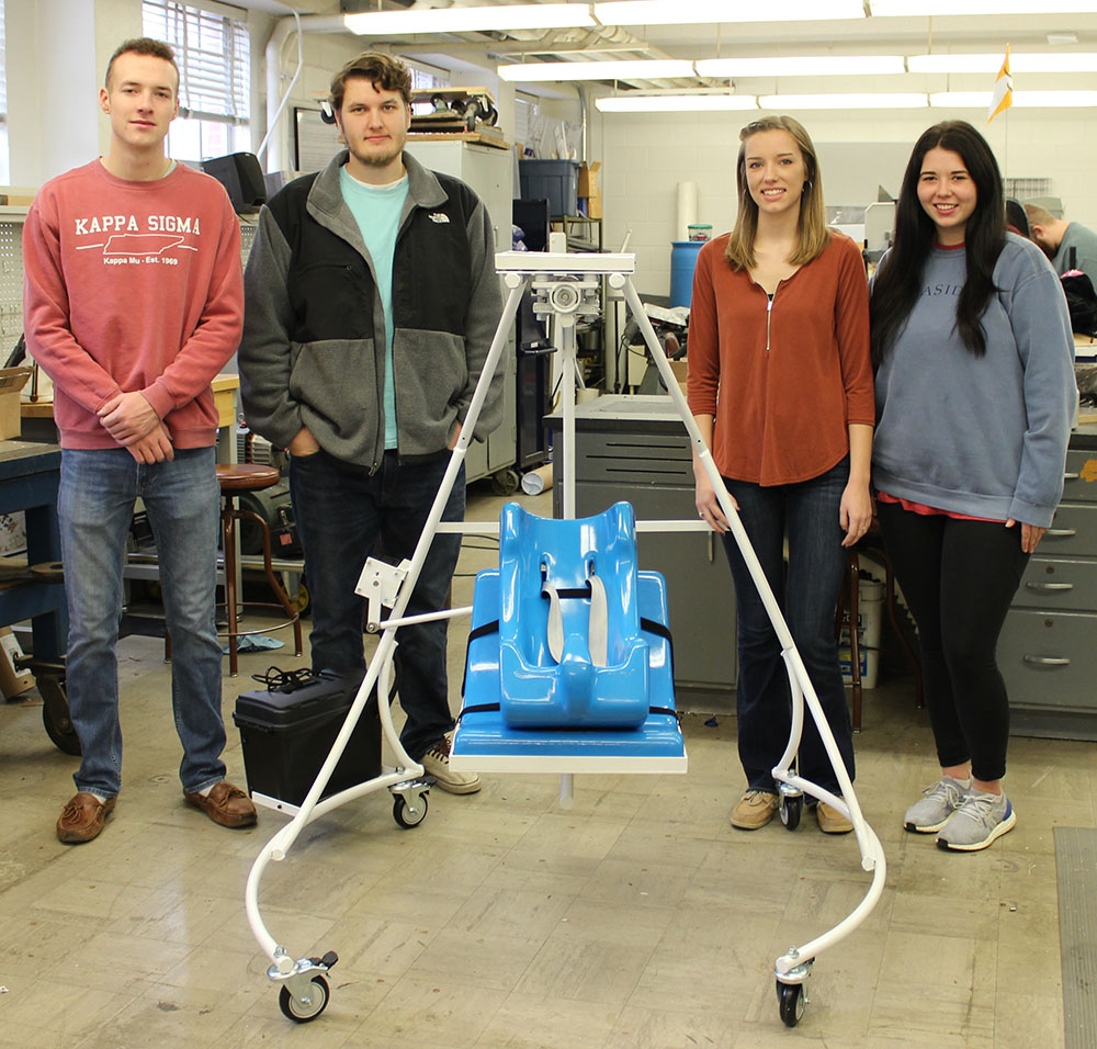 Four students standing with their child swing project