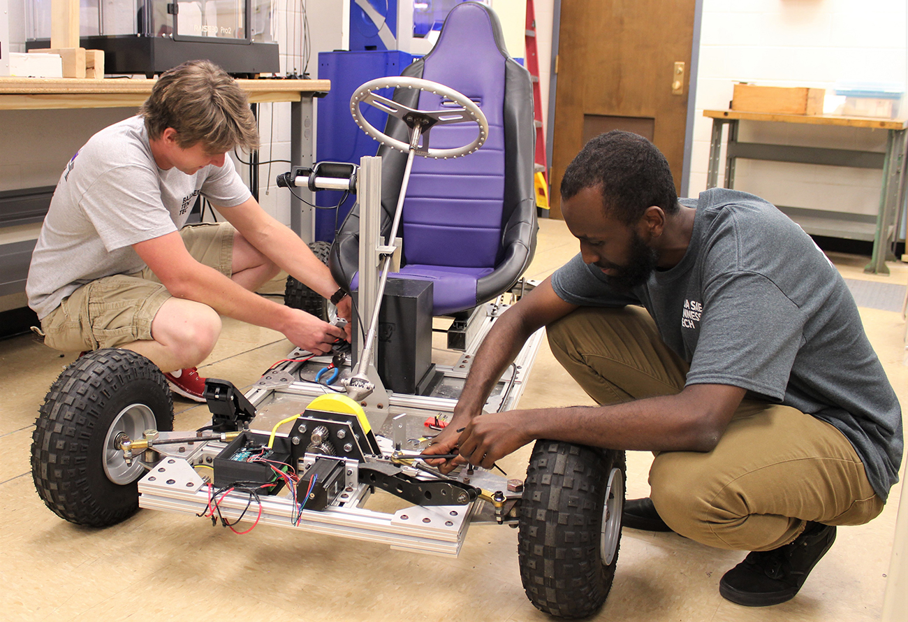 Students working on go kart