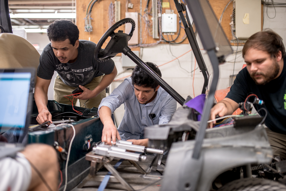 Students working on a golf cart project