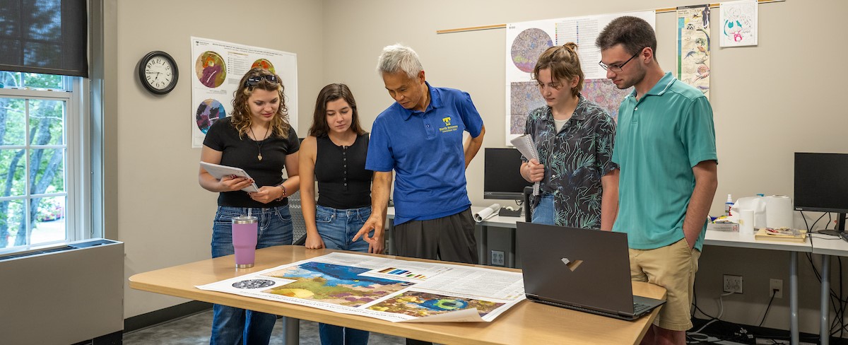 Students and Professor looking at Map