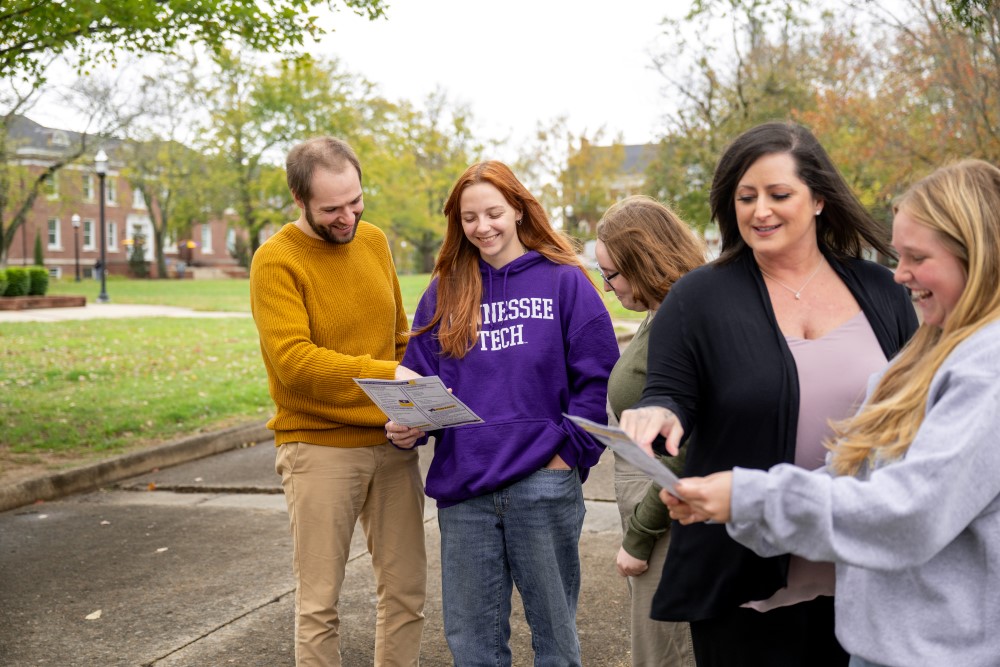 Two FA Members helping students