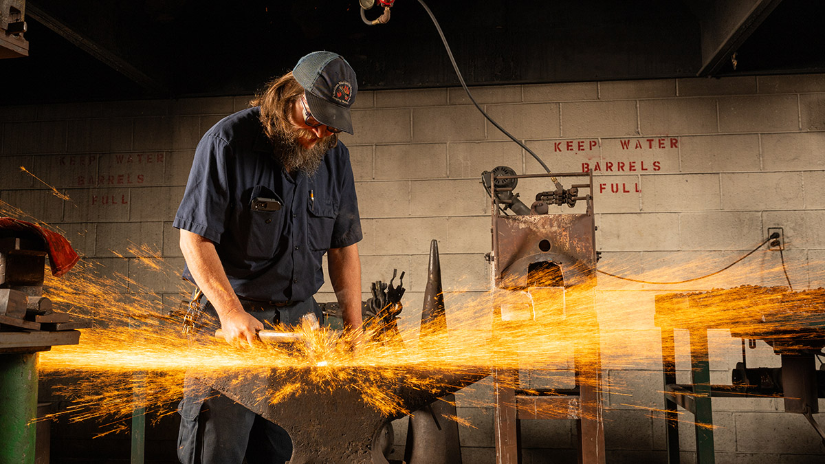 A workshop student in the backsmithing studio.