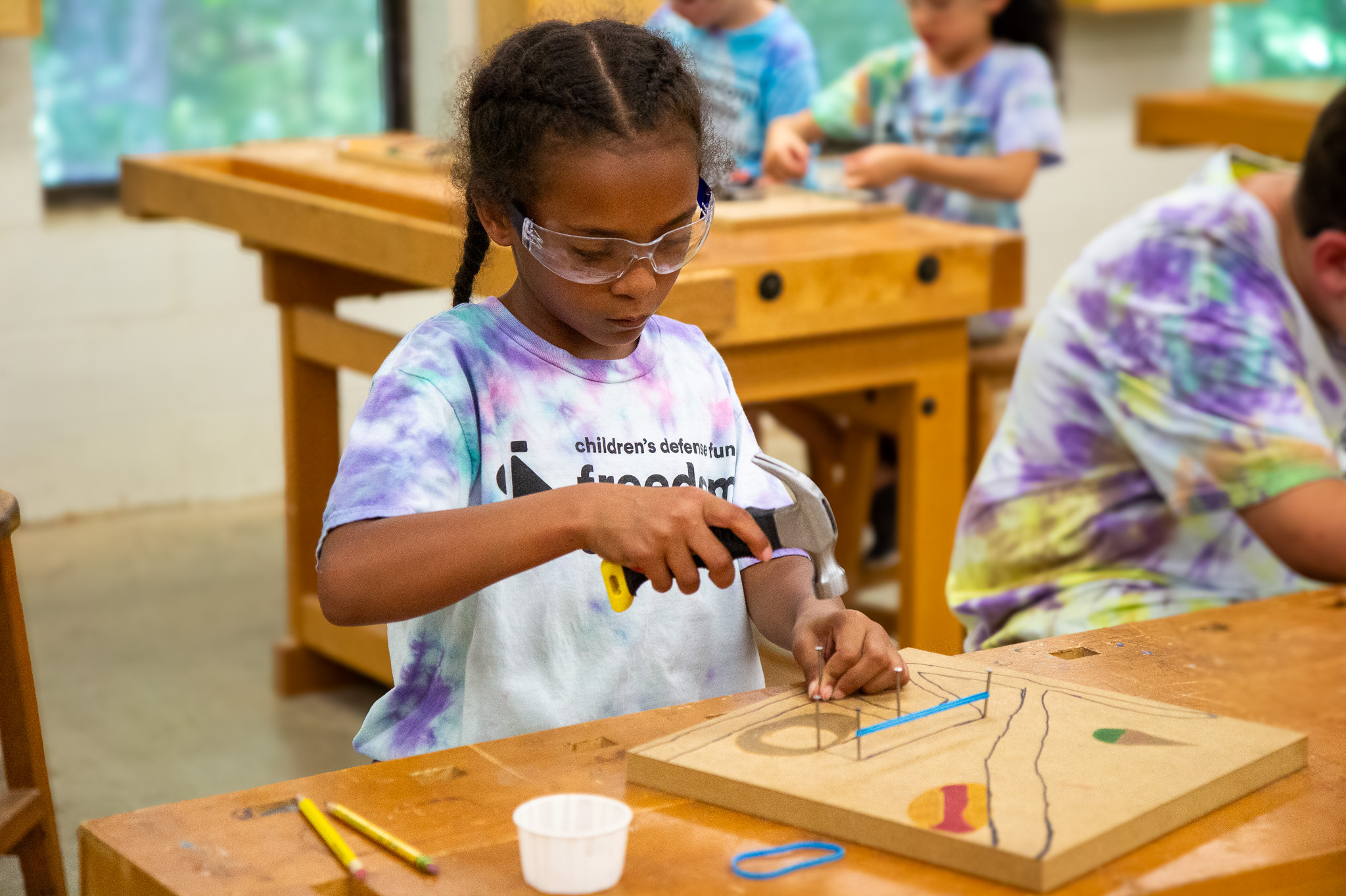 child holding hammer