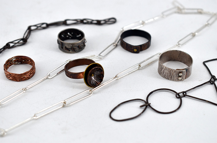 Metal jewelry layed across a table