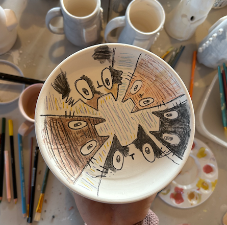Inside of clay plate with cartooning