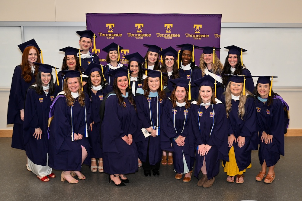 Students graduating from Tennessee Tech University taking a group photo at commencement.