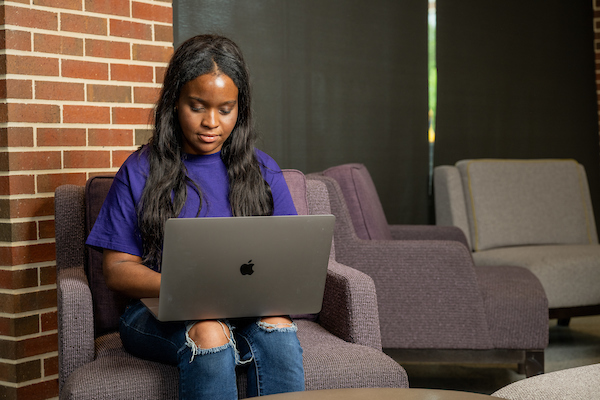 Student on a laptop in the library.