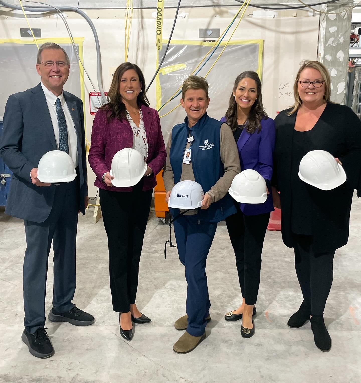 Amy New and other key comminity members posing with hardhats