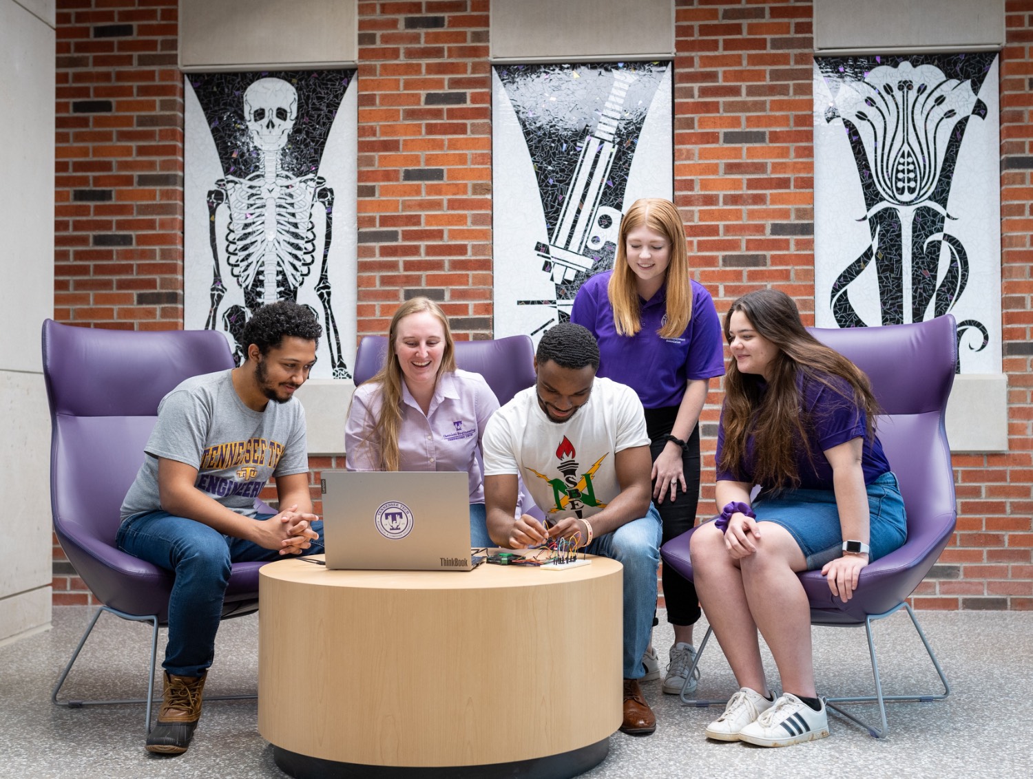 students sitting in lounge smiling