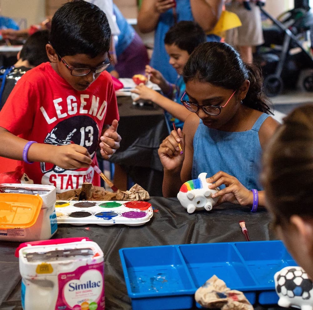 Students painting at STEM Center