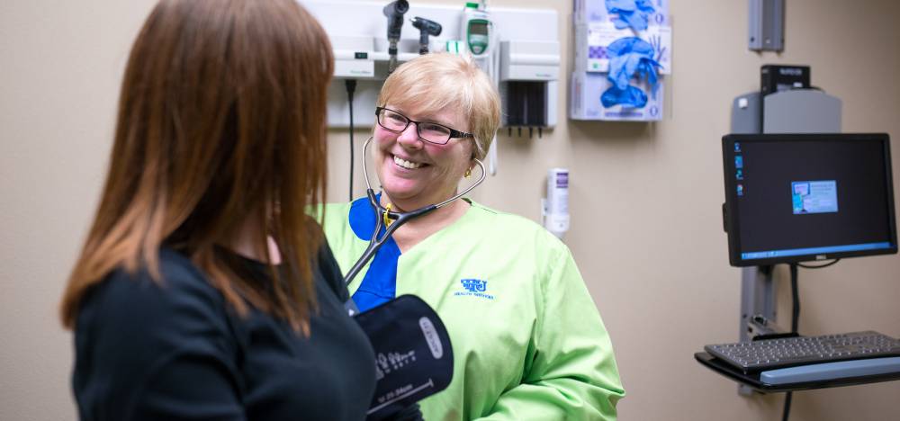 A nurse speaking to a patient