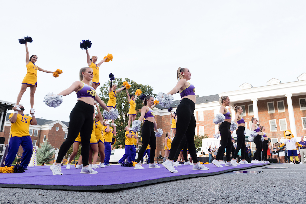 Cheer team performing stunts.