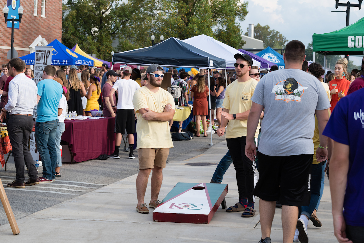 Students playing corn hole.