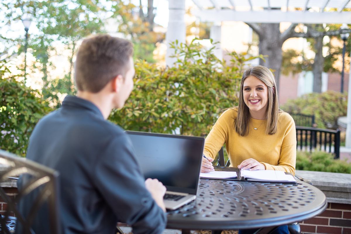 A student working at an outdoor table