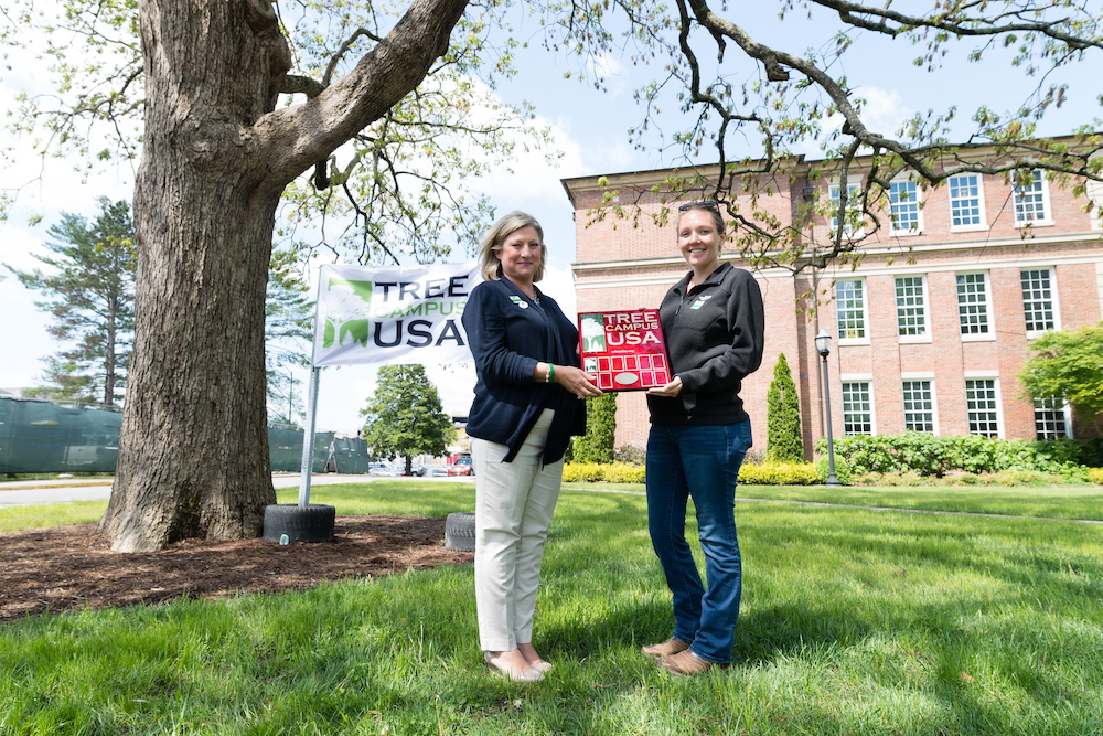 Tennessee Tech provost Lori Bruce and Jaime Nunan with the City of Cookeville display a plaque recoognizing Tech's campus as a 2018 Tree Campus USA by the Arbor Day Foundation for the first time in university history.