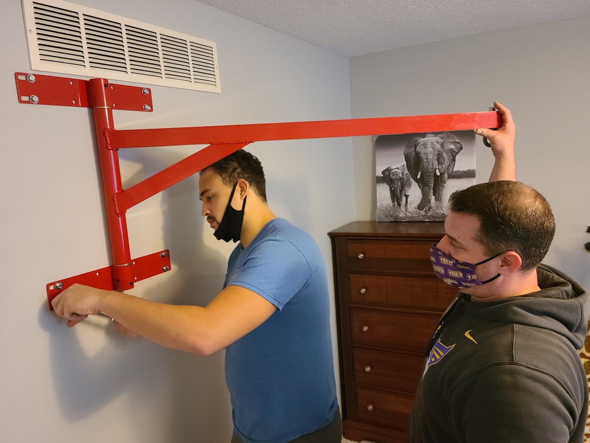 Tennessee Tech mechanical engineering students Gabriel DaSilva and John Wagner help install a sensory swing for an autistic child.