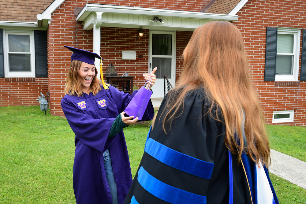 Graduating senior Erin Higgins gets visit and a goodie bag from Jennifer Shank, the dean of the College of Fine Arts.