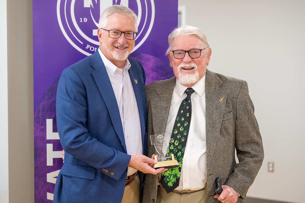 Tech President Phil Oldham (left) presents Allen McCampbell with a placard recognizing his more than 20 years of service on the Tennessee Tech Foundation Board. 
