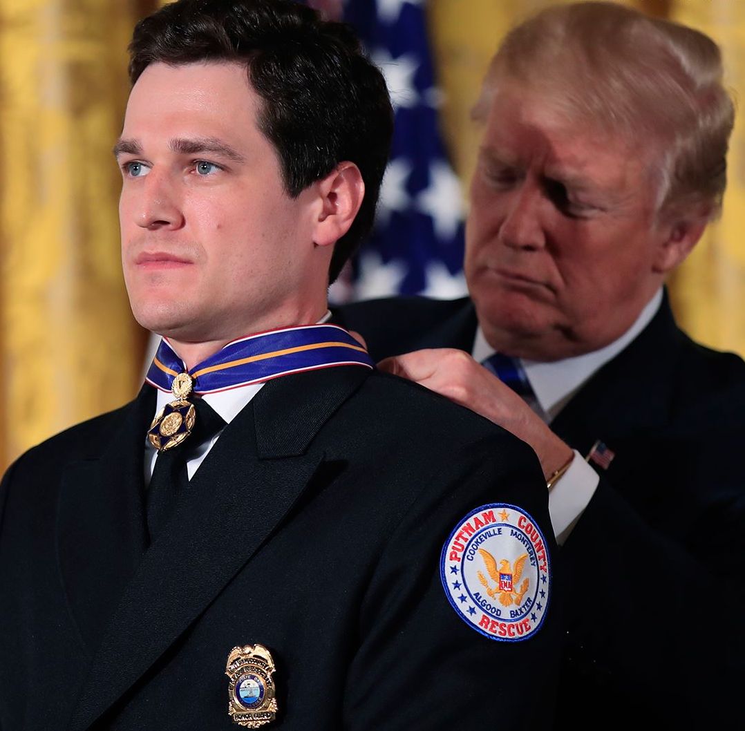 Ochsenbein receives the Public Safety Officer Medal of Valor award from then-President Donald Trump. 